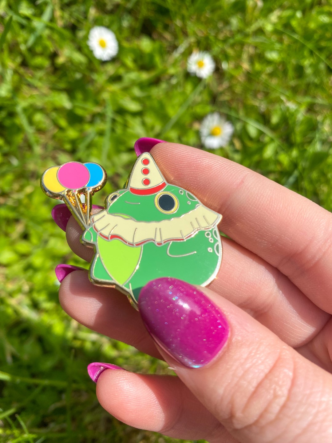 Photo of clown frog enamel pin
